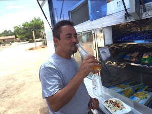 Tony, forefront, grabs an orange drink at El Crazy Fish.