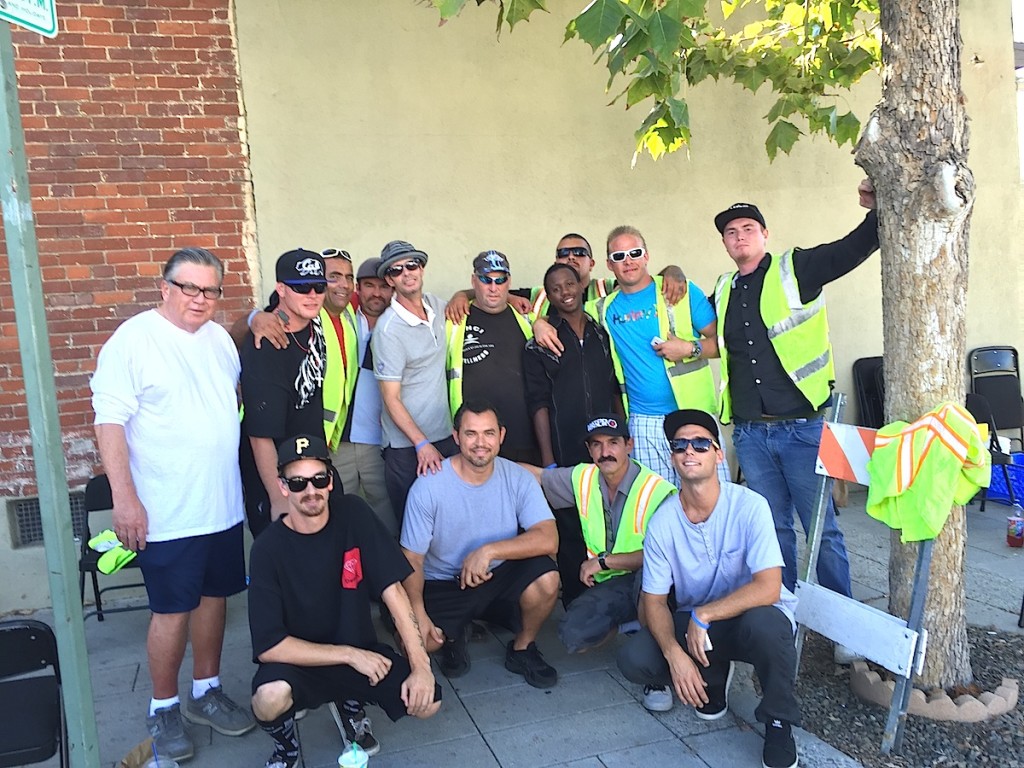 Volunteers from a local rehab program prepare to set up barricades during the event.