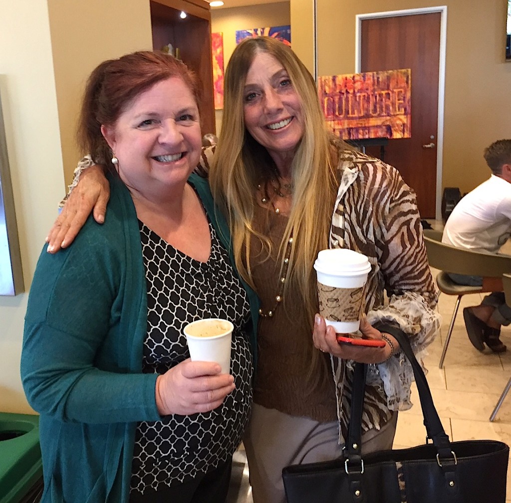 Meeting of the media: Shera Sandwell, right, embraces Kathy Valentine, UT sale rep at CULTURE opening.