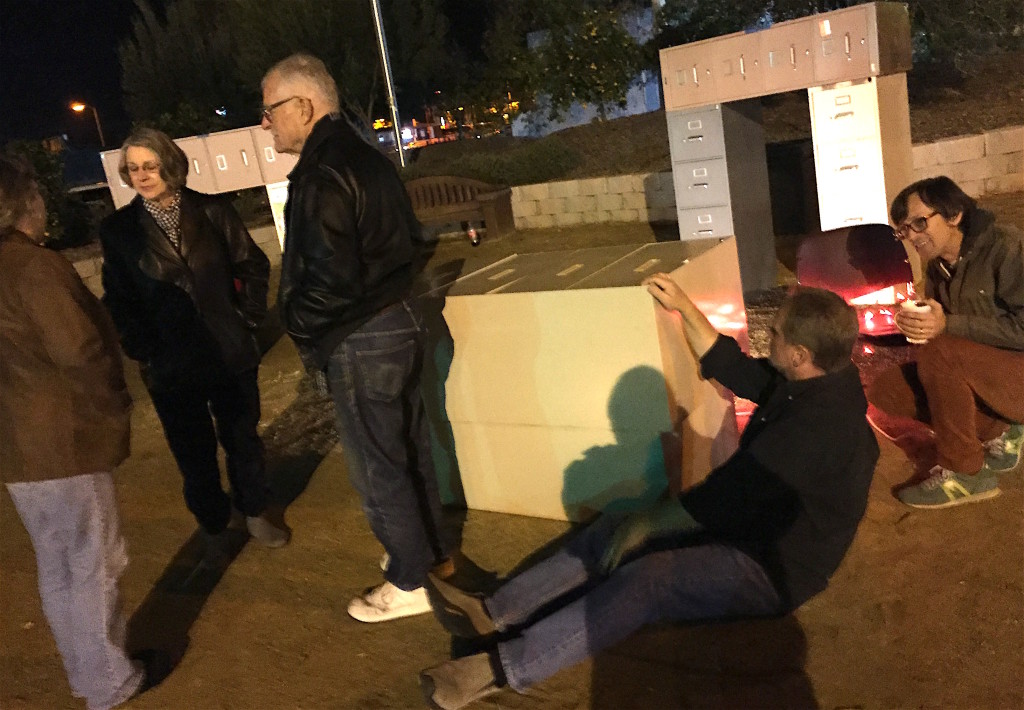 SDSU art Matt Hebert, far right, mingles with art fans around his file cabinet Stonehenge installation at Heritage Garden Park.