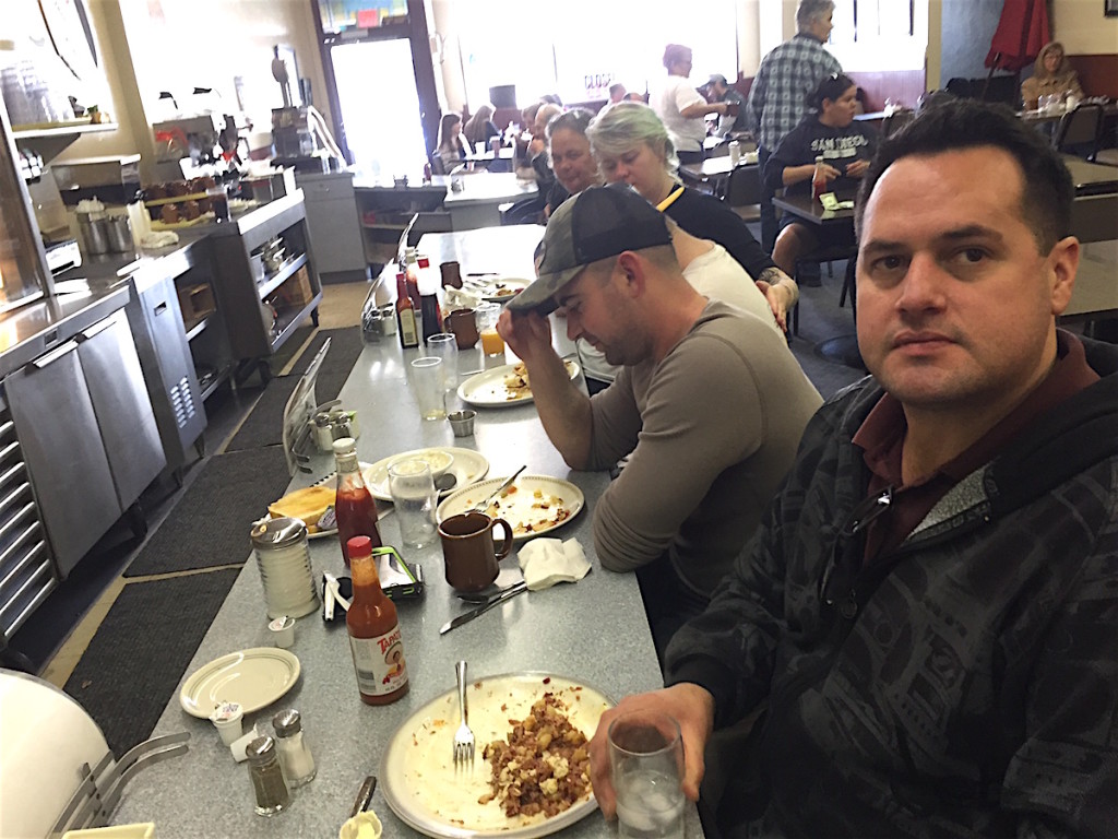 Escondido educational administrator Austin MacKay, corned beef hash on his plate, forefront said he brought cousin, and Escondido firefighter, Forrest Payne, left for last chance meals at Champion’s.