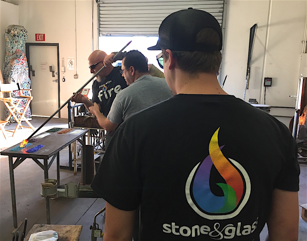 James Stone, far left, works with student Lino Tagliepeteria while shop assistant Jon Noble looks on.