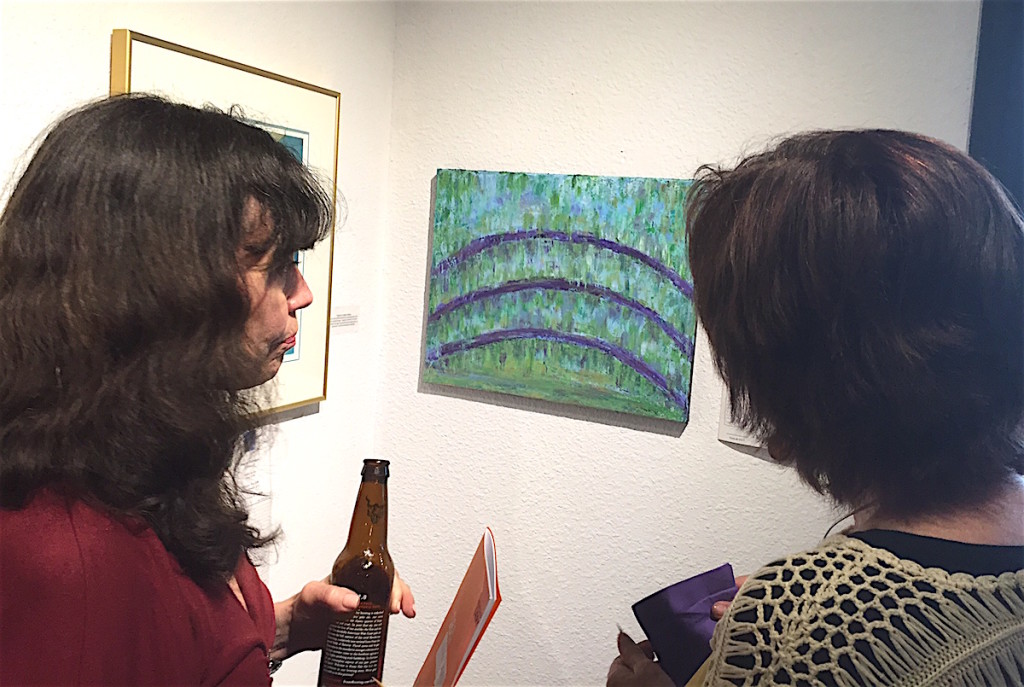 Patrons checking out Gladys Jimenez’s abstract art work for auction.