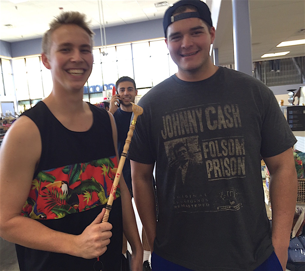 Cal State University San Marcos students Kyle Skachenko, left, and Jimbo Stumpff, with an unidentified colleague photobombing, stopped in while waiting for a friend to get his towed car back.