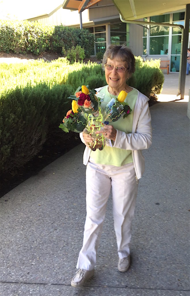 Dana Behmer carried a Valley Center high School Floriculture Club display back to the car that would take it back to school.