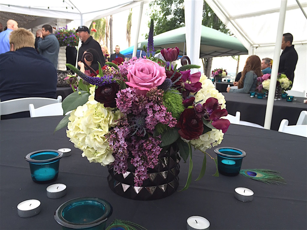 Floral arrangement amidst wedding party.