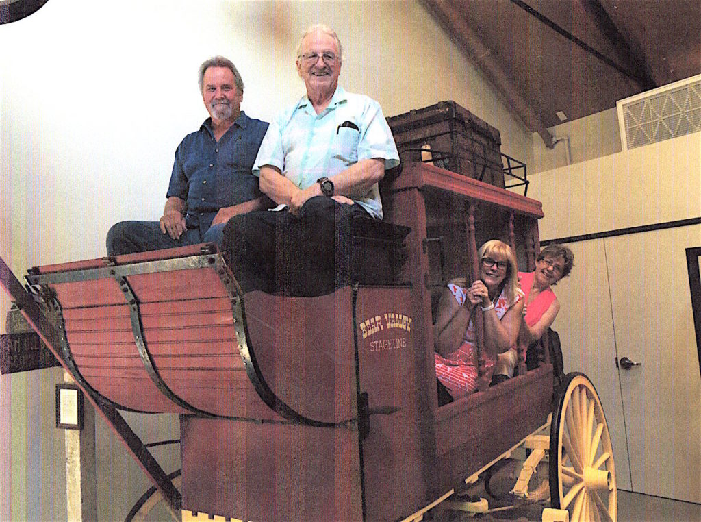 All aboard: officers of the Valley Center History Museum pose in the historic 1848 stagecoach which is the centerpiece of a new wing at the museum.  Pictured are Earl Brown (top left). William Boyett, Nicky Lovejoy and Lynne Boyett.