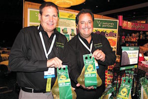 Giumarra Agricom International LLC salesman Joseph Casey (left) and director of marketing Gary Caloroso show off Giumarra’s new avocado bags July 14 at the Fresh Produce & Floral Council’s Southern California Expo in Anaheim. Photo by Tom Burfiled